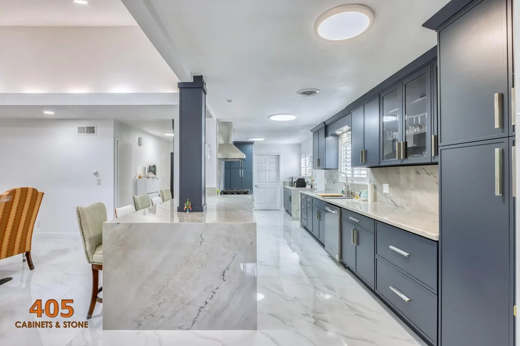 A long kitchen design with dark blue cabinets